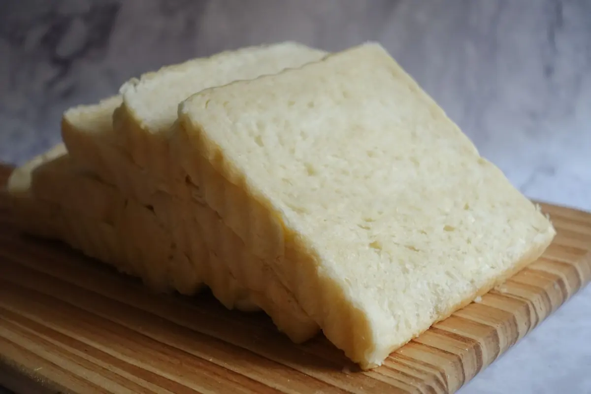 A sliced loaf of bread on a board
