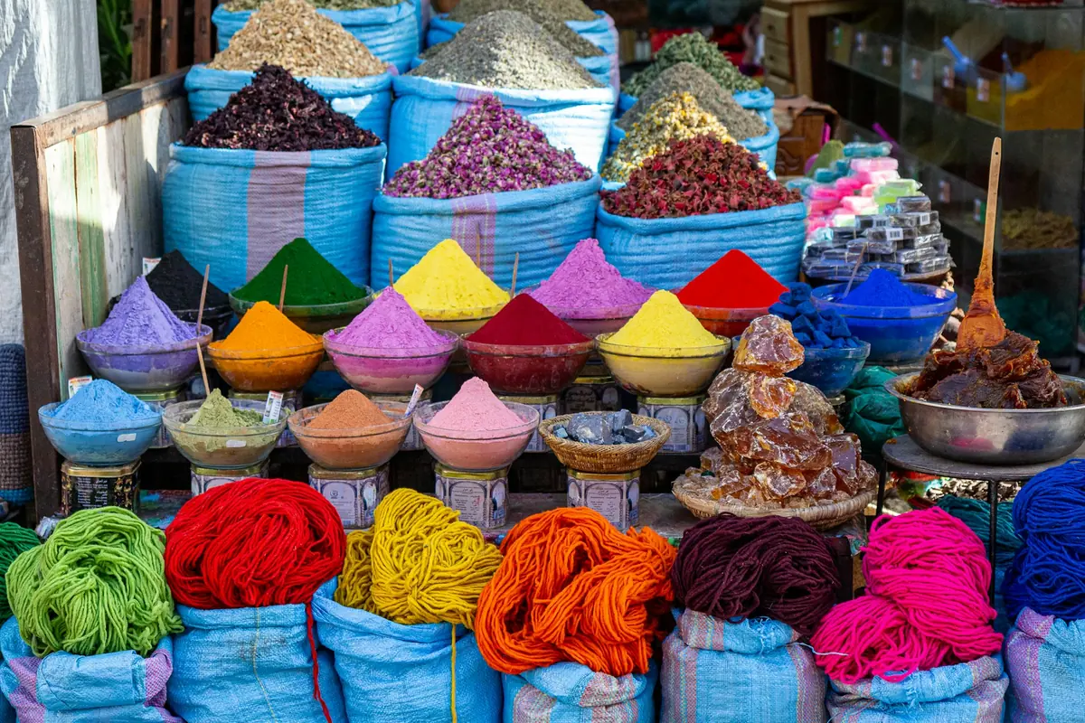Bowls of colourful spices on display at a market