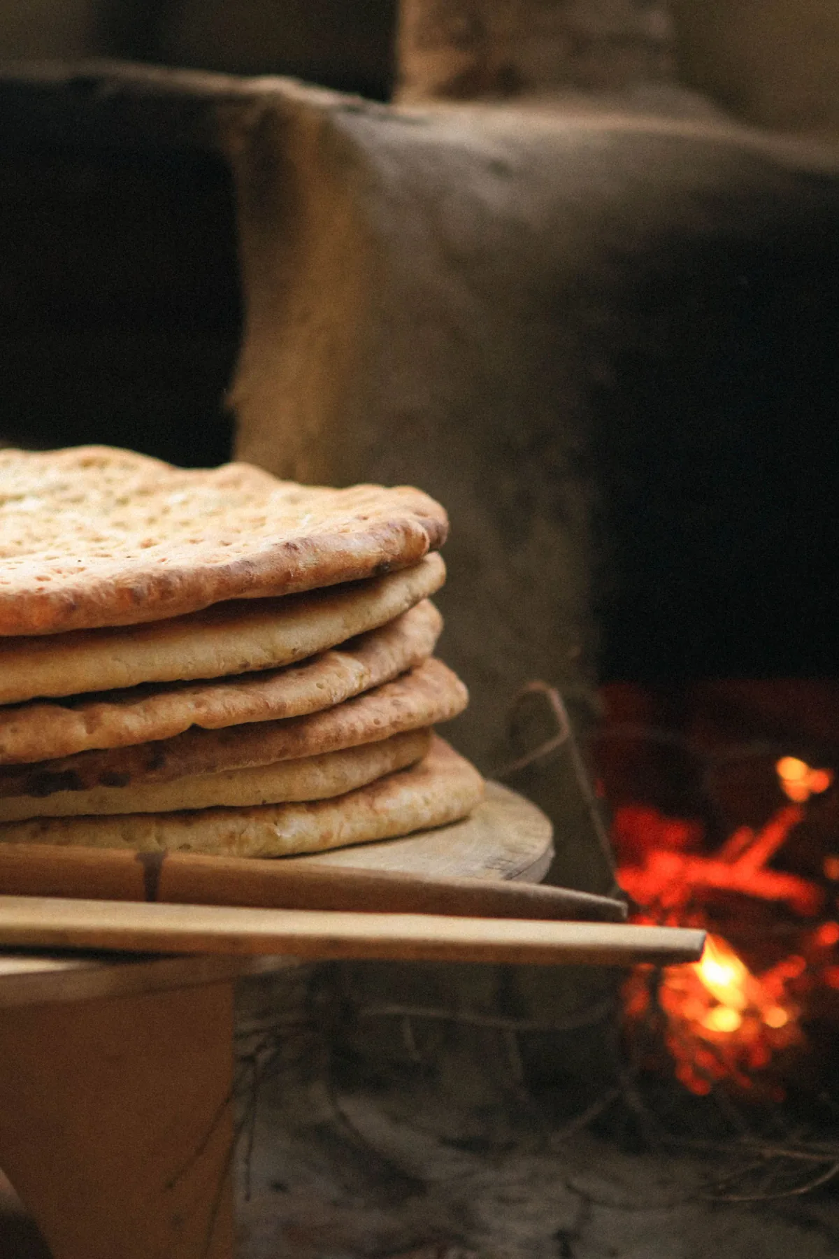 A stack of traditional flatbreads in warm light