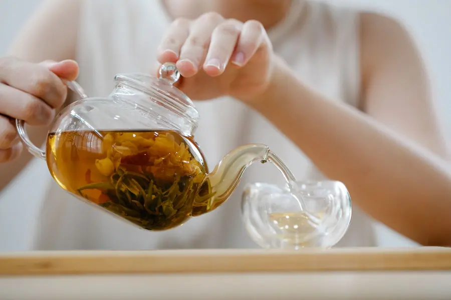 Tea being poured into a glass