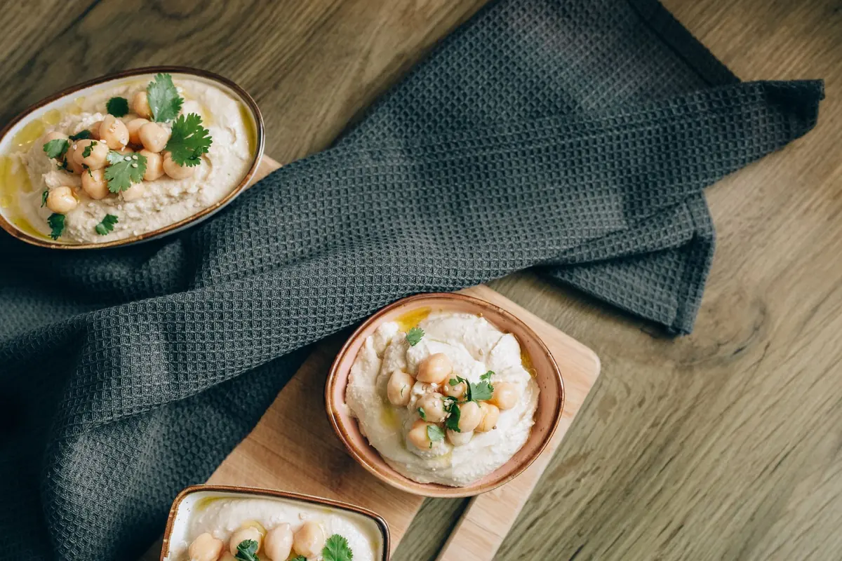 Three small bowls of different Mediterranean sauces