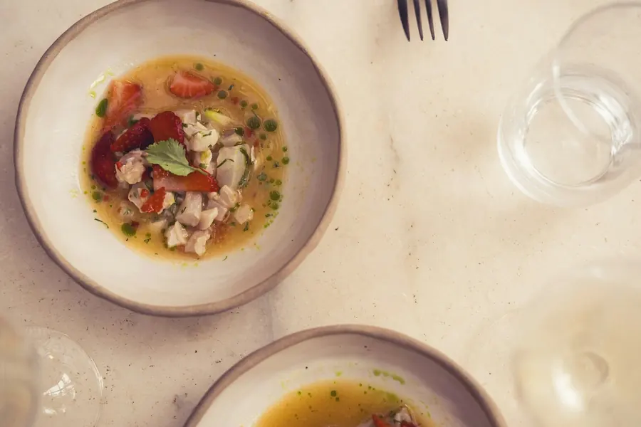 Tomatoes, olive oil and basil on a rustic table