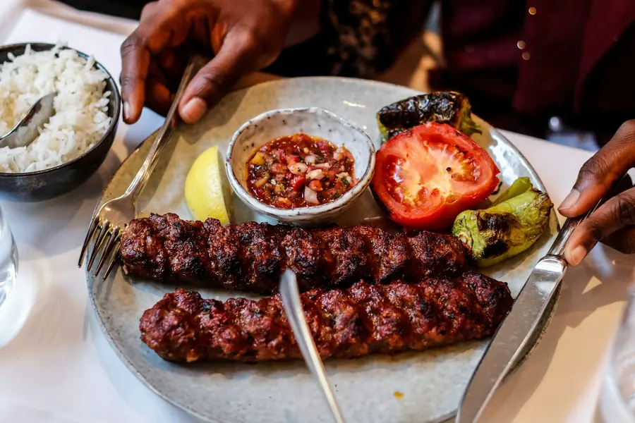 Skewers of meat cooking on a Turkish grill