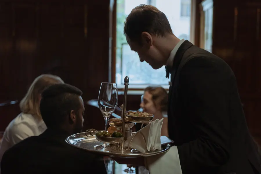 A server bringing food to a table