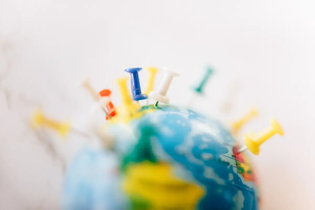 A world map marked with pins