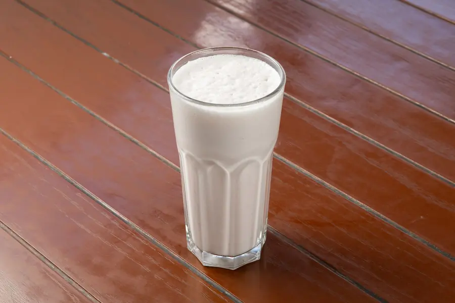 A frothy yogurt drink in a glass